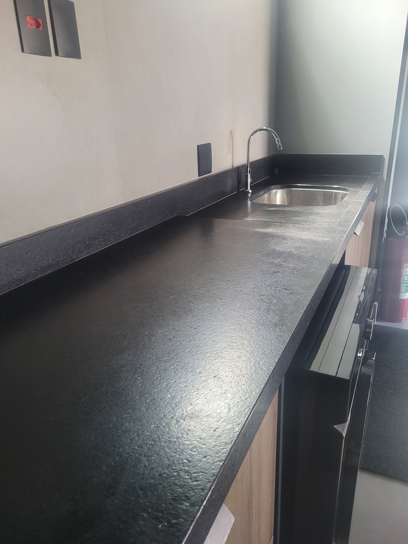 Superfície da bancada escovada com cuba de inox ao fundo